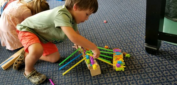 Preschool child building a colorful block structure